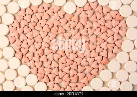 Heart made of vitamins for pets on beige background, flat lay Stock Photo