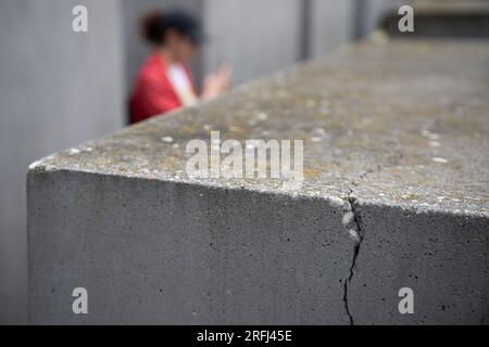 Berlin, Germany. 03rd Aug, 2023. View of a stele with a crack in the concrete. Many of the more than 2700 concrete stelae of the Holocaust Memorial near the Brandenburg Gate show cracks. Credit: Hannes P. Albert/dpa/Alamy Live News Stock Photo