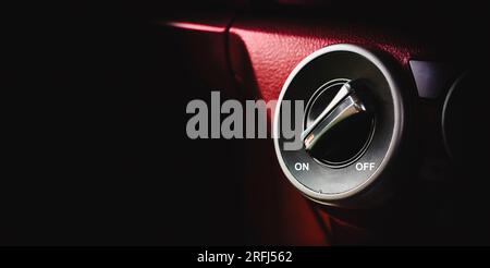 Rotation button switch on dashboard, on off switch, panoramic banner with copy space for text. Stock Photo