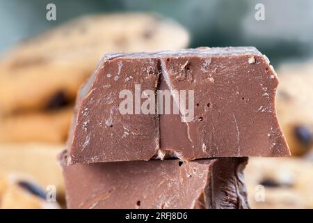 very sweet pieces of chocolate on the table, broken chocolate and wheat cookies with chocolate drops, fast food items, very high calorie cocoa food Stock Photo