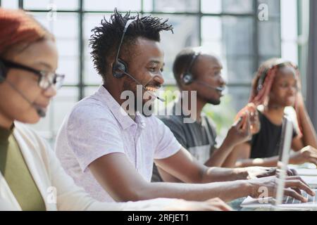 call center agents smiling happy working at the office. Stock Photo