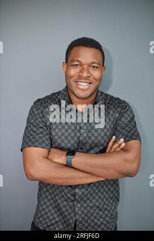 Portrait of an attractive cool guy on a gray background Stock Photo