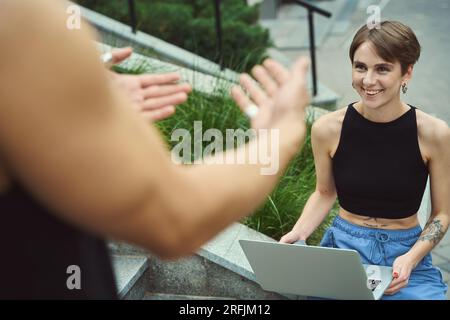 Smiling woman looking at her boyfriend outside Stock Photo