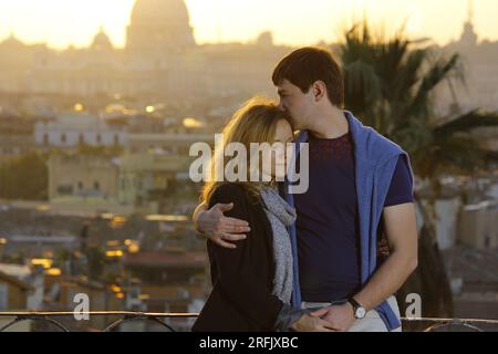 portrait of loving couple embracing in Rome, Italy. aticano is on background. High quality photo Stock Photo