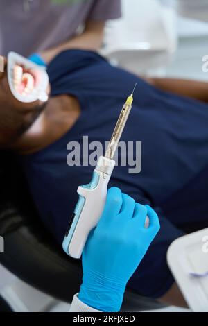 African dentist woman holding electric toothbrush and normal toothbrush