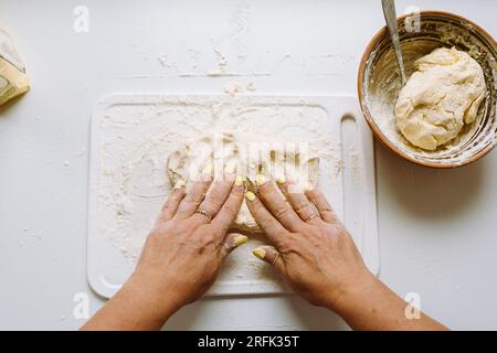 Female hands knead dough Stock Photo