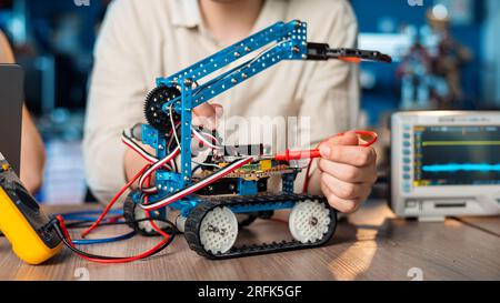 Man doing experiments in robotics in a laboratory using special tools Stock Photo