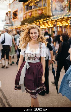Portrait of a young woman wearing bavarian dirndl dress at Oktoberfest Stock Photo