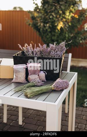 Bouquets of fresh lavender and bags with dried lavender on table Stock Photo