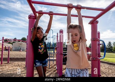 School aged children playing on monkey bars Stock Photo