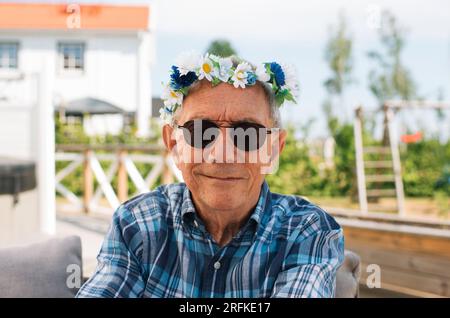portrait of man wearing swedish midsummer headband at midsommar Stock Photo