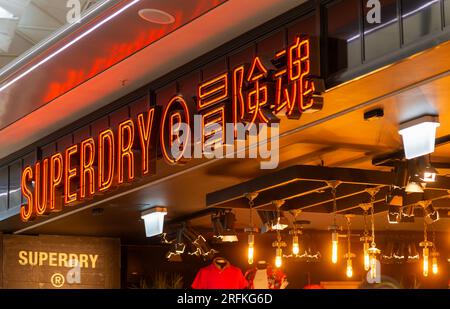 Neon sign Superdry store shop, London Stansted Airport, Essex, England, UK Stock Photo