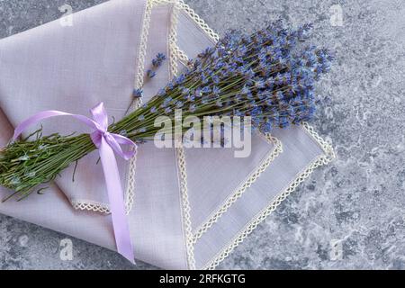 A bouquet of lavender on gray stone table with a napkin. Top view. Flat lay Stock Photo