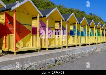 Recoloured beach huts called No.1054 Arpeggio by artist Rana Begum are part of the Folkestone Triennial 2021 along the seafront in Folkestone, UK. Stock Photo