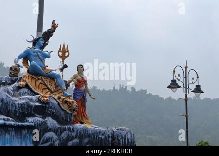 Giant statue of Lord Shiva and Parvati at Triveni Ghat, Rishikesh, with Lord Shiva sitting on the back of a tiger and Goddess Ganga. Stock Photo