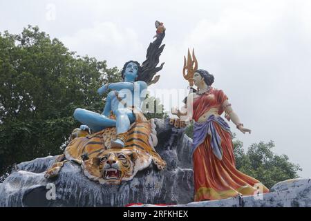 Giant statue of Lord Shiva and Parvati at Triveni Ghat, Rishikesh, with Lord Shiva sitting on the back of a tiger and Goddess Ganga. Stock Photo