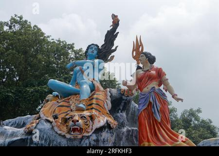 Giant statue of Lord Shiva and Parvati at Triveni Ghat, Rishikesh, with Lord Shiva sitting on the back of a tiger and Goddess Ganga. Stock Photo