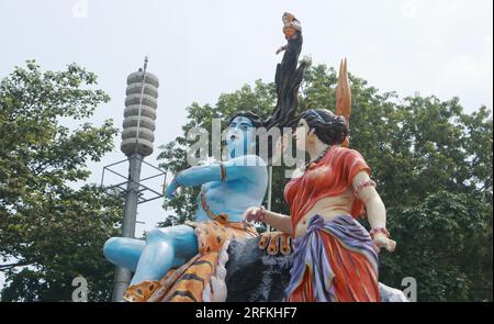 Giant statue of Lord Shiva and Parvati at Triveni Ghat, Rishikesh, with Lord Shiva sitting on the back of a tiger and Goddess Ganga. Stock Photo