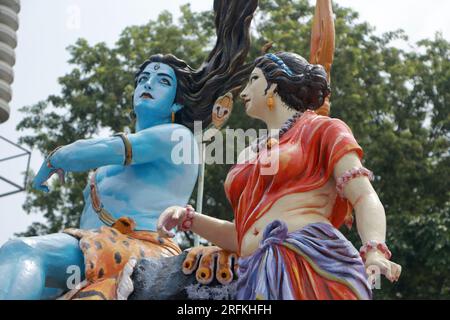 Giant statue of Lord Shiva and Parvati at Triveni Ghat, Rishikesh, with Lord Shiva sitting on the back of a tiger and Goddess Ganga. Stock Photo