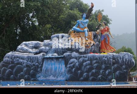 Giant statue of Lord Shiva and Parvati at Triveni Ghat, Rishikesh, with Lord Shiva sitting on the back of a tiger and Goddess Ganga. Stock Photo