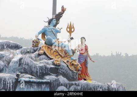 Giant statue of Lord Shiva and Parvati at Triveni Ghat, Rishikesh, with Lord Shiva sitting on the back of a tiger and Goddess Ganga. Stock Photo