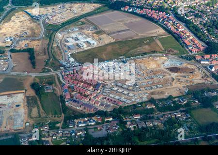 Oblique aerial view through plane window of construction of new housing estate in Bishop's Stortford town, Essex, England, UK Stock Photo