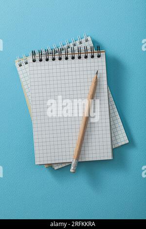Notepads With Pencil On Blue Background Stock Photo