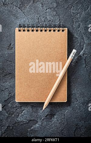 Wooden Pencil On Opened Notepad Black Stone Background Stock Photo