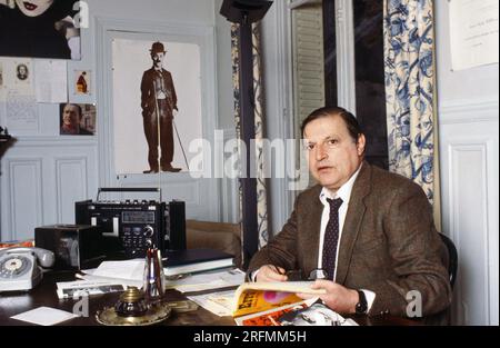 French film journalist Claude-Jean Philippe at home in Paris, c.1985. Stock Photo