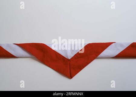 The triangular-shaped scarf that is worn as part of the uniform in the Indonesian Scout Movement Pramuka has red and white color called Hasduk Stock Photo