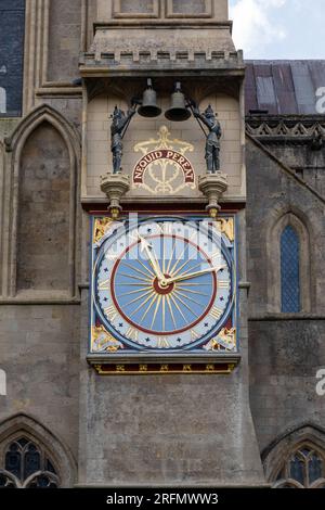 The historic external Wells Cathedral Clock with jousting knights chiming the bell every 15 minutes. City of Wells, Somerset, England, UK Stock Photo