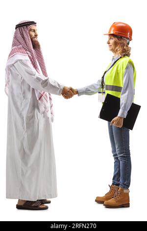 Full length profile shot of a saudi arab man shaking hand with a female engineer isolated on white background Stock Photo
