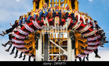 Herne, Germany. 04th August, 2023 People on the 85 metre high 'Hangover - The Tower' ride. Cranger Kirmes funfair is one of the largest in Germany. The popular fair regularly attracts more than 4m visitors during its 10 day run. The fair dates back to the early 18th century at Crange. Credit: Imageplotter/Alamy Live News Stock Photo