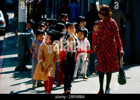 Teacher leading her class in Chinatown, San Francisco, California, USA Stock Photo