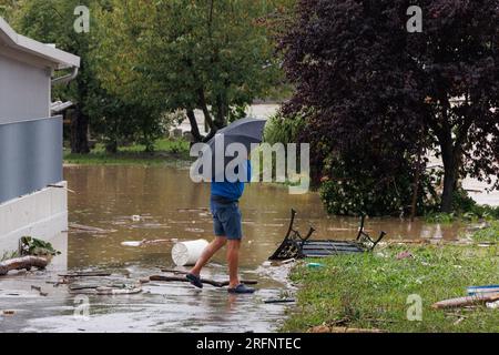 Medvode, Slovenia. 4th Aug, 2023. A man walks past a flooded driveway after a flood in Medvode. Heavy continuous torrential rain and storms have caused major flooding all throughout Slovenia in the first part of the forecasted severe weather event. Roads and railroads were closed, several areas had no electricity or drinking water, and fatalities were reported. (Credit Image: © Luka Dakskobler/SOPA Images via ZUMA Press Wire) EDITORIAL USAGE ONLY! Not for Commercial USAGE! Credit: ZUMA Press, Inc./Alamy Live News Stock Photo