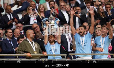 Manchester City's Bernardo Silva lifts the FA Cup trophy as he celebrates winning the Emirates FA Cup final at Wembley Stadium, London. Picture date: Saturday June 3, 2023. See PA Story SOCCER Final. Photo credit should read: Nick Potts/PA Wire. RESTRICTIONS: EDITORIAL USE ONLY No use with unauthorised audio, video, data, fixture lists, club/league logos or 'live' services. Online in-match use limited to 120 images, no video emulation. No use in betting, games or single club/league/player publications. Stock Photo