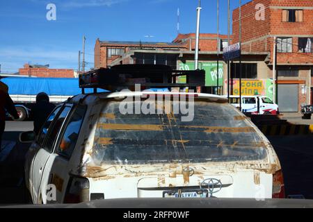 White Toyota taxi with rear window replaced by clear plastic sheet and tape, El Alto, Bolivia Stock Photo