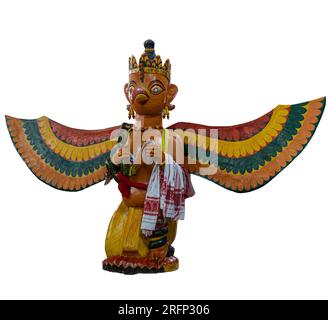 Isolated photo of a statue of Garuda, the vahana of Vishnu, from Auniati Satra (monastery) on Majuli Island, Assam, India. Garuda's arm is draped with Stock Photo