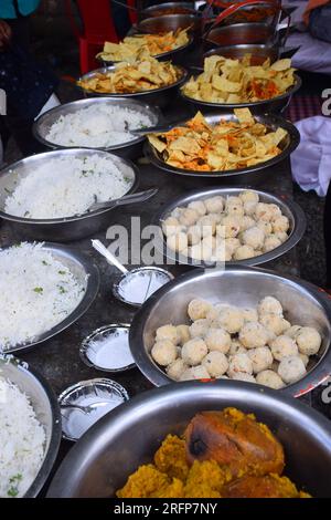 sweets for indian hindu marriage, gulab jamun, cashew katli and snacks placed in steel plate Stock Photo