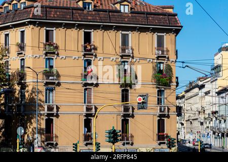 Milan apartment building with woman on balcony Stock Photo