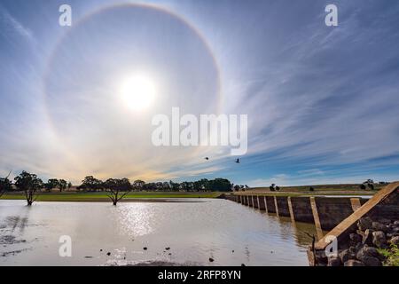 A complete solar halo and disused railway bridge over Cairn Curran Reservoir in Central Victoria, Australia Stock Photo