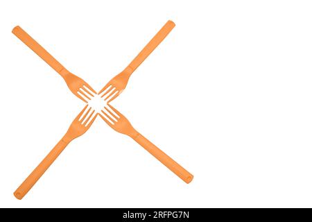 Four orange plastic forks for camping, travel isolated on white surface Stock Photo