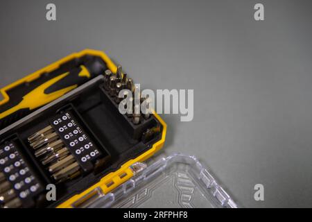Screwdriver bit set. Metal bits for screwdriver boxes. A set of tools for home use. Screwdriver bits and adapters. Hex head in different sizes. Stock Photo