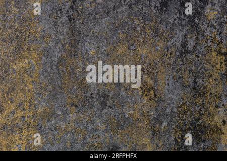 Old faded yellow cement wall surface and black mold. indicative of a period Stock Photo