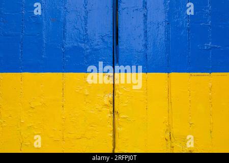 Wooden gate painted in the Ukrainian flag colours Stock Photo