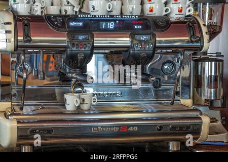 espresso machine makingv two coffee cups in a bar, Italy Stock Photo