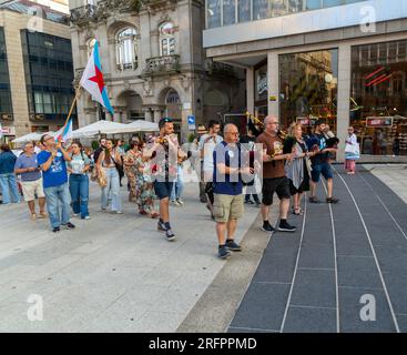 Bagpipe playing musicians BNG political party election campaign in plaza Praza Porto do Sol, city centre of Vigo, Galicia, Spain July 2023 Stock Photo