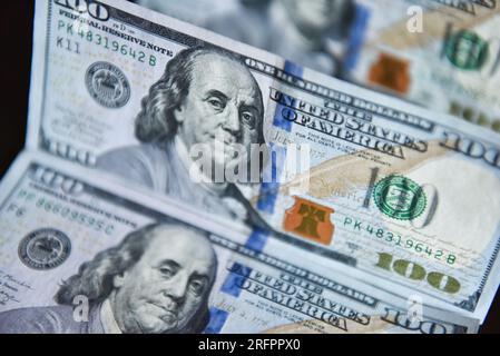 China. 05th Aug, 2023. In this photo illustration, 100 dollar bills seen displayed on a table. Credit: SOPA Images Limited/Alamy Live News Stock Photo