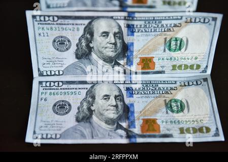 China. 05th Aug, 2023. In this photo illustration, 100 dollar bills seen displayed on a table. Credit: SOPA Images Limited/Alamy Live News Stock Photo