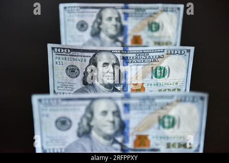 China. 05th Aug, 2023. In this photo illustration, 100 dollar bills seen displayed on a table. Credit: SOPA Images Limited/Alamy Live News Stock Photo